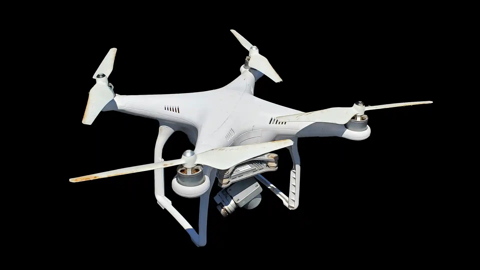 White quadcopter drone isolated on black background.